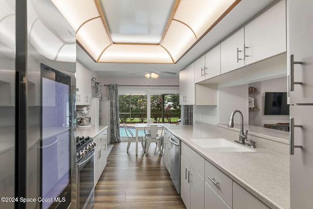 kitchen with dark hardwood / wood-style floors, white cabinetry, and sink