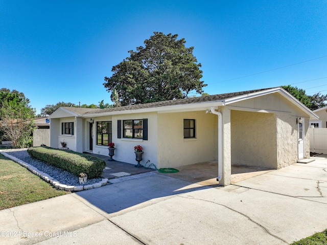 ranch-style home with a carport