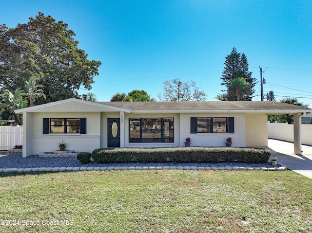 1037 Poinsetta St, Cocoa, FL 32927 - ranch-style house featuring driveway, stucco siding, brick siding, a carport, and a shingled roof