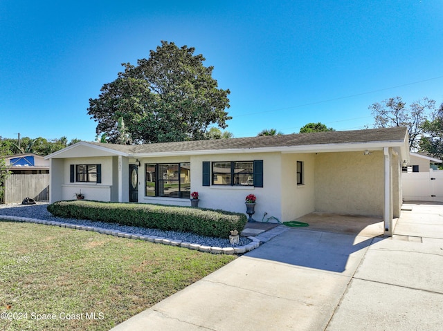 1037 Poinsetta St, Cocoa, FL 32927 - ranch-style home featuring stucco siding, driveway, and a carport