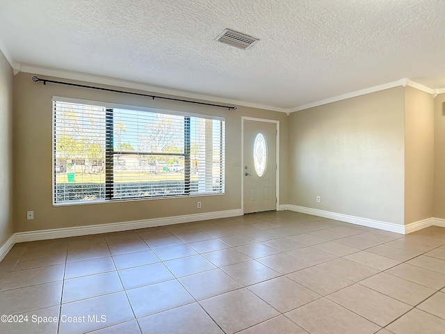 1037 Poinsetta St, Cocoa, FL 32927 - entrance foyer with a textured ceiling, crown molding, light tile patterned flooring, and baseboards