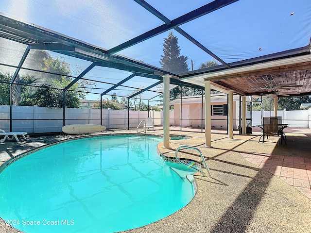 view of pool with ceiling fan, a patio area, and a lanai