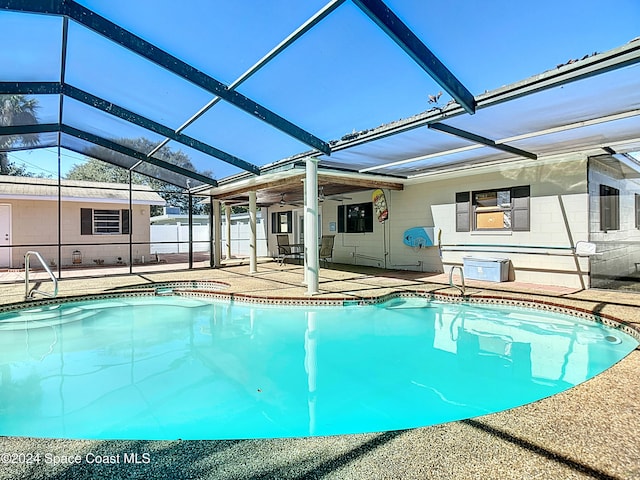 view of pool with a lanai, ceiling fan, and a patio area