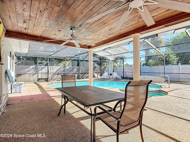 view of swimming pool featuring a patio area and a lanai