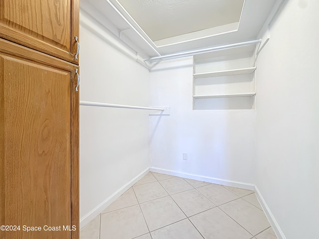 spacious closet featuring light tile patterned floors