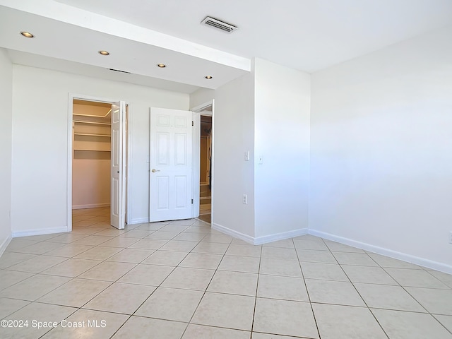 1037 Poinsetta St, Cocoa, FL 32927 - unfurnished bedroom featuring recessed lighting, baseboards, light tile patterned floors, and a spacious closet