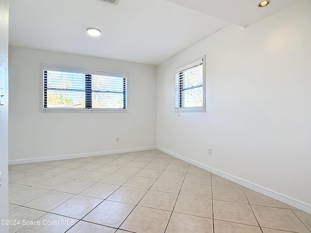 1037 Poinsetta St, Cocoa, FL 32927 - spare room with healthy amount of natural light, light tile patterned floors, baseboards, and recessed lighting