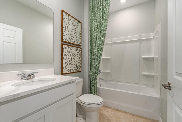 full bathroom with tile patterned floors, shower / bath combo with shower curtain, vanity, and toilet