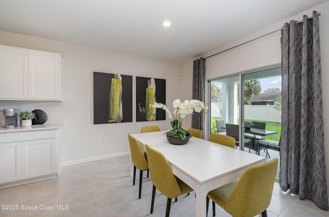 dining area featuring light tile patterned flooring, recessed lighting, and baseboards