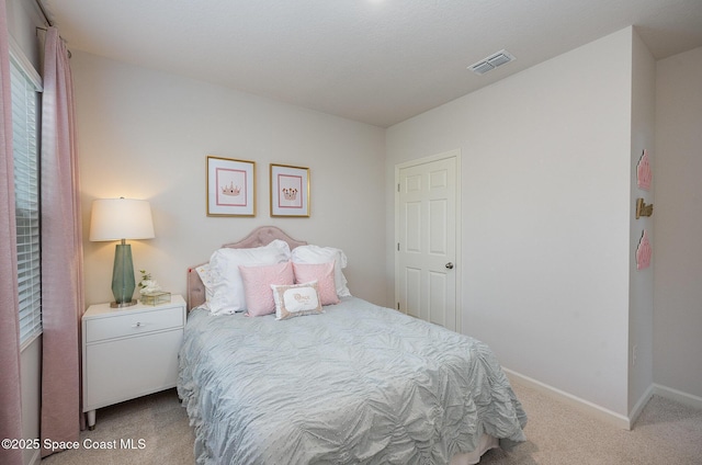 carpeted bedroom featuring visible vents and baseboards