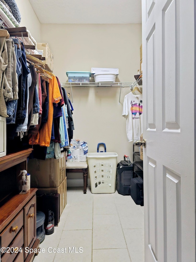 spacious closet with light tile patterned floors