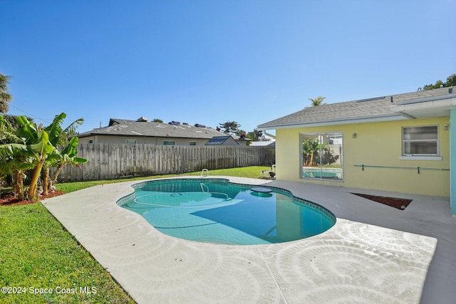 view of swimming pool with a patio area