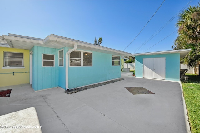 exterior space with a patio and a storage unit