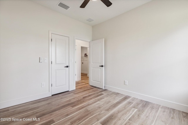 unfurnished bedroom with ceiling fan and light hardwood / wood-style floors