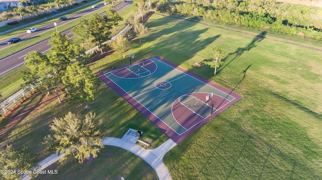 view of basketball court with a yard