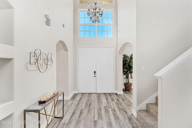 entryway featuring light hardwood / wood-style floors and an inviting chandelier