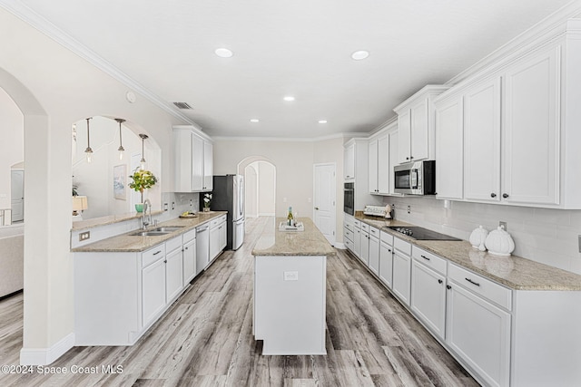 kitchen with white cabinetry, sink, stainless steel appliances, and light hardwood / wood-style floors