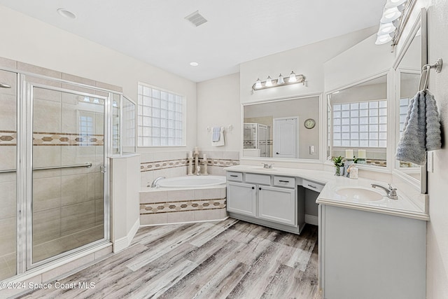 bathroom featuring hardwood / wood-style floors, vanity, plenty of natural light, and independent shower and bath