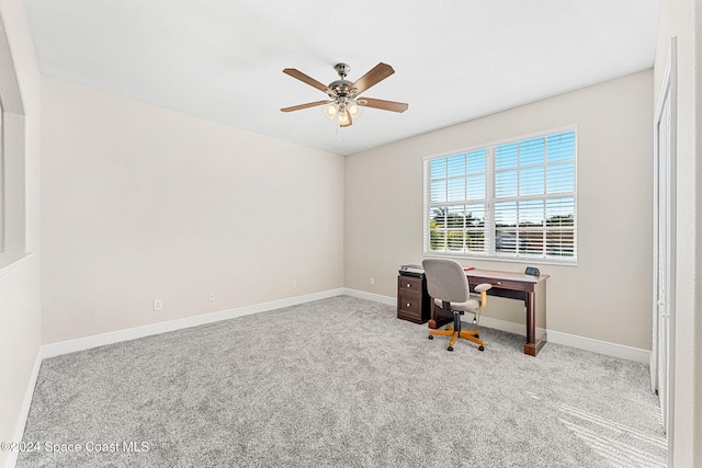 carpeted office space featuring ceiling fan