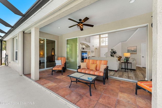 exterior space with ceiling fan and an outdoor living space