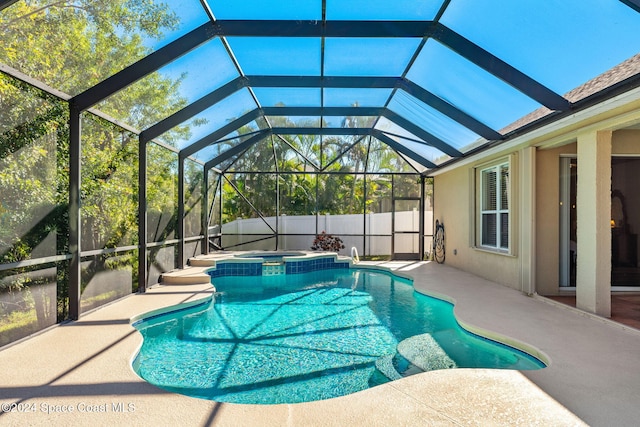 view of swimming pool with a lanai, an in ground hot tub, and a patio