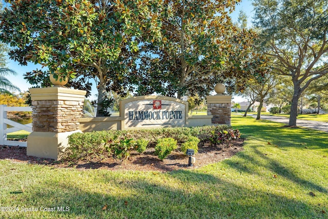 community / neighborhood sign with a yard