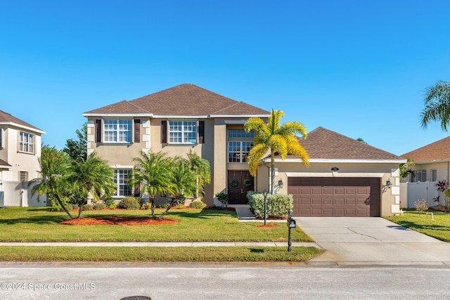 view of front of house featuring a garage and a front lawn