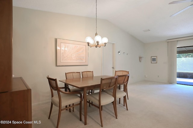 dining area with light carpet, ceiling fan with notable chandelier, and lofted ceiling