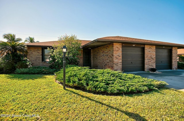 ranch-style house with a front yard and a garage