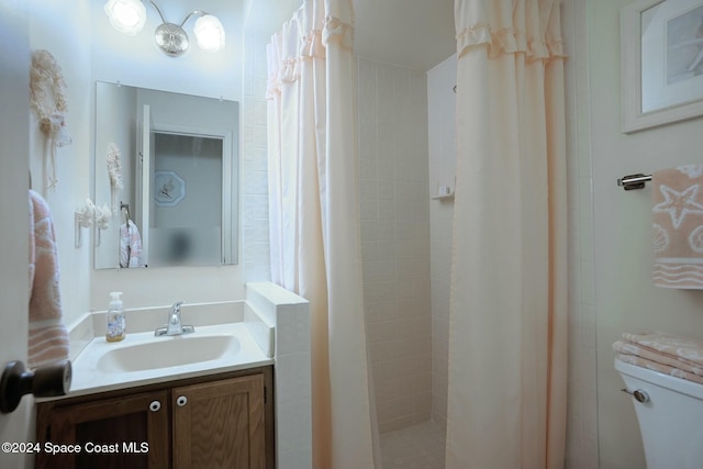 bathroom featuring vanity, toilet, and walk in shower