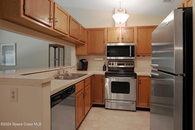 kitchen featuring kitchen peninsula, stainless steel appliances, sink, pendant lighting, and lofted ceiling