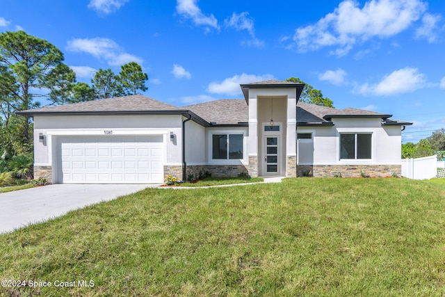 view of front of property with a front yard and a garage