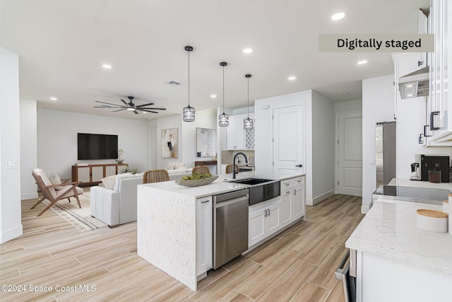 kitchen with white cabinetry, sink, stainless steel dishwasher, an island with sink, and decorative light fixtures