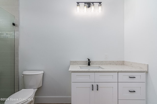 bathroom featuring vanity, toilet, and walk in shower