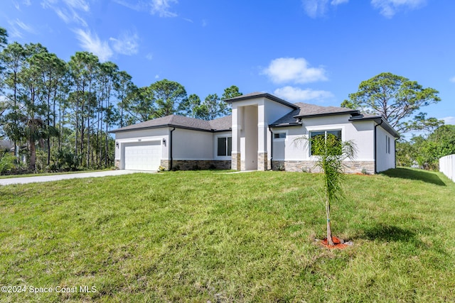 view of front of property with a garage and a front lawn