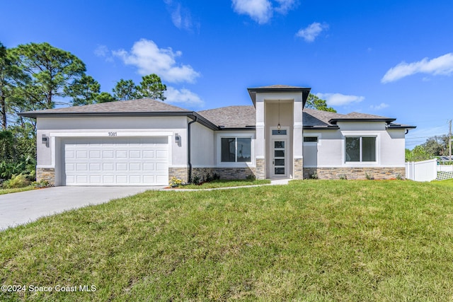 view of front of home featuring a garage and a front lawn