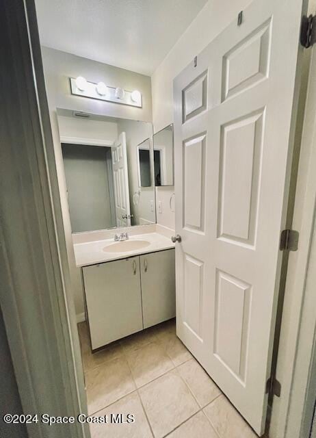 bathroom featuring tile patterned flooring and vanity