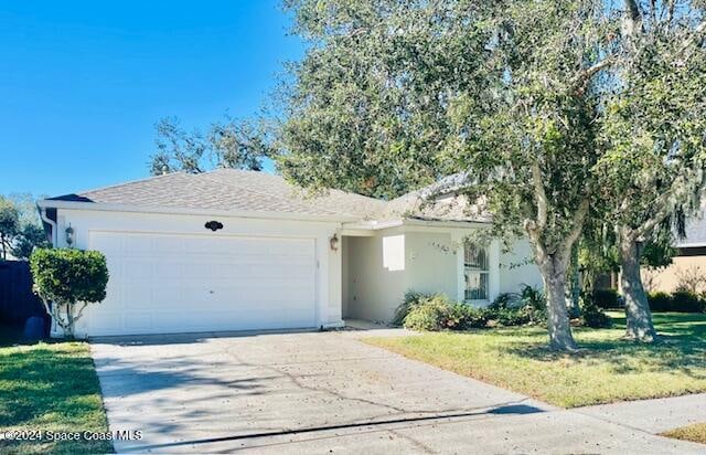 ranch-style home with a garage and a front yard