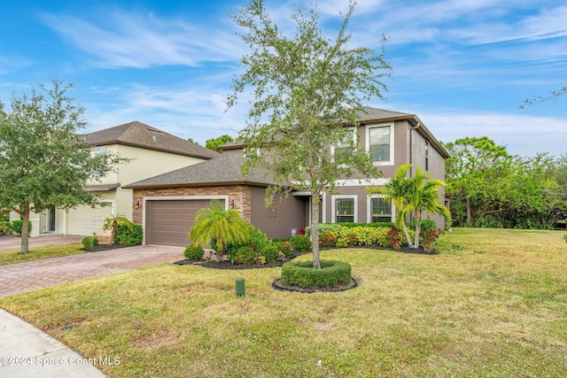 view of front of home with a front yard and a garage