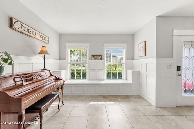 miscellaneous room featuring light tile patterned floors and a textured ceiling