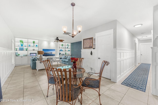 dining area with built in features, light tile patterned floors, and ceiling fan with notable chandelier