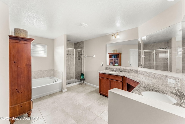 bathroom with tile patterned floors, independent shower and bath, and a textured ceiling