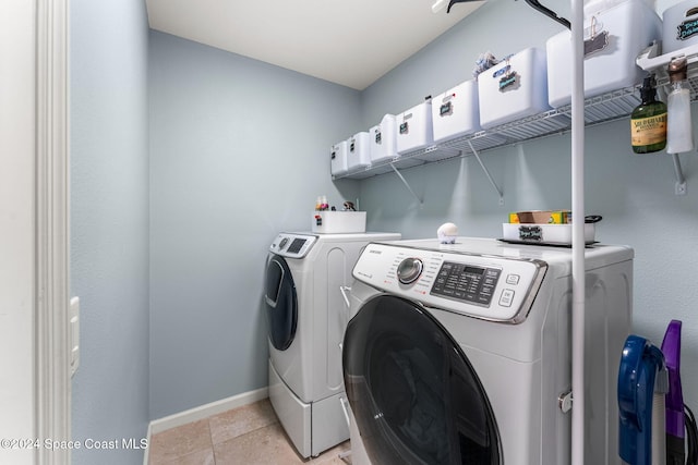 washroom featuring separate washer and dryer and light tile patterned flooring