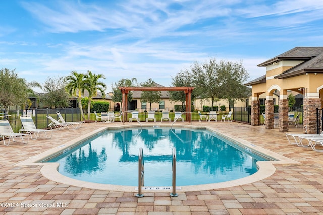 view of swimming pool featuring a pergola and a patio area