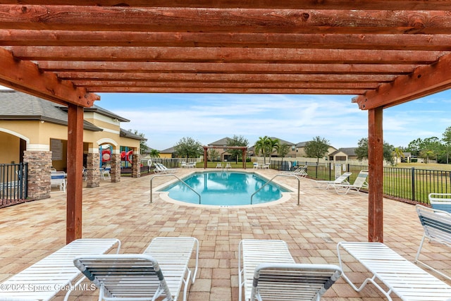 view of swimming pool featuring a pergola and a patio