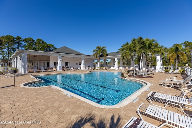 view of pool with a patio area and ceiling fan