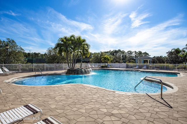 view of pool with pool water feature and a patio