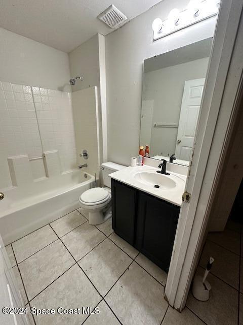 full bathroom with tile patterned floors, vanity,  shower combination, and toilet