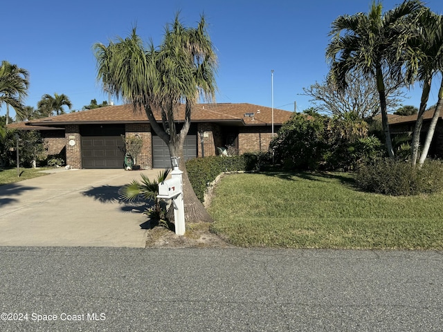 view of front of home with a garage and a front yard