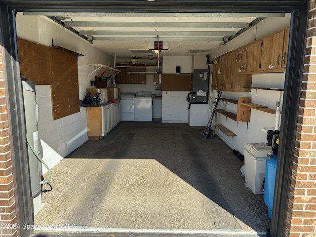 garage with washer and dryer and a garage door opener